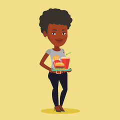 Image showing Woman holding tray full of fast food.