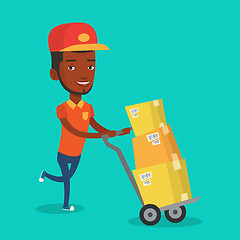 Image showing Delivery postman with cardboard boxes on trolley.