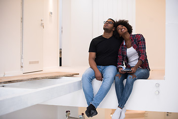 Image showing couple having break during moving to new house