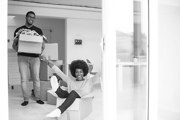 Image showing African American couple  playing with packing material