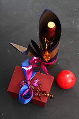 Image showing Packaging holiday gifts. Decoration of bottles, packaging bottles of wine