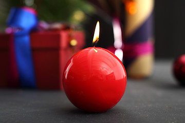 Image showing Beautifully wrapped gift Red candle, festive atmosphere in the house