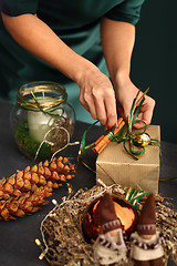 Image showing Packaging holiday gifts. Christmas decorations idea of a handmade gift.