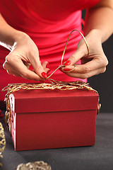 Image showing Things you need to pack gifts Woman packs gifts, step by step Woman packs Christmas gift