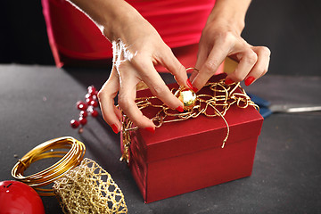 Image showing How to wrap a gift for Christmas? Gift wrapping. Christmas gift idea how to decorate a gift