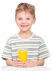 Image showing Little boy drinking orange juice