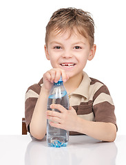 Image showing Little boy with plastic bottle of water