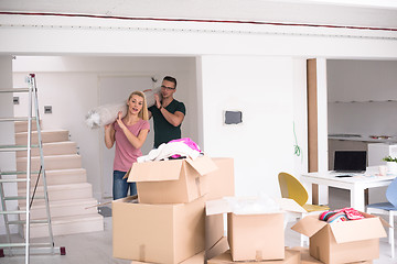 Image showing couple carrying a carpet moving in to new home