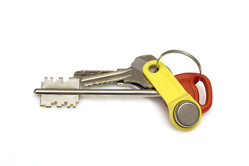 Image showing Keys to the apartment on white background. The concept of the popularity new housing