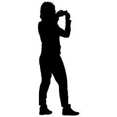 Image showing Silhouettes woman taking selfie with smartphone on white background