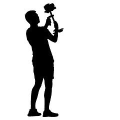 Image showing Cameraman with video camera steadicam . Silhouettes on white background