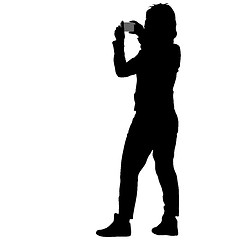 Image showing Silhouettes woman taking selfie with smartphone on white background