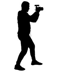 Image showing Cameraman with video camera. Silhouettes on white background