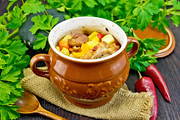 Image showing Roast meat and potatoes in pot on board