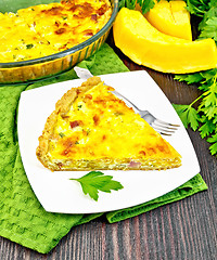Image showing Quiche with pumpkin and bacon in plate on green towel