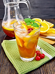 Image showing Lemonade with cherries in glassful and jug on board