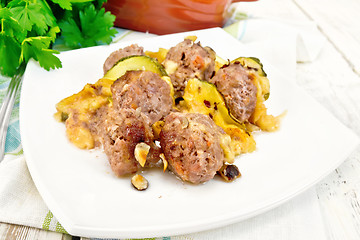 Image showing Meatballs with zucchini and nuts in plate on board