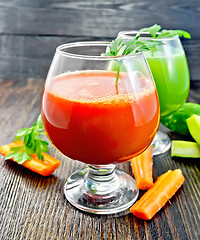 Image showing Juice carrot and cucumber in two wineglass on dark board