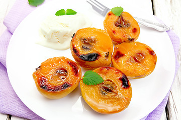 Image showing Quince baked with ice-cream in plate on napkin