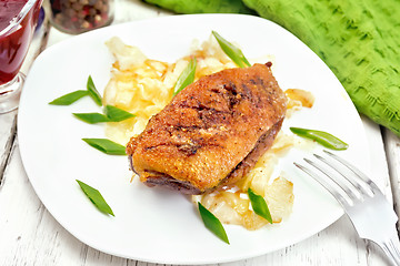 Image showing Duck breast with cabbage and onions in plate on board