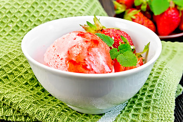 Image showing Ice cream strawberry with syrup in bowl on green napkin