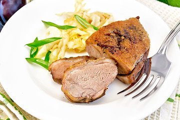 Image showing Duck breast with cabbage and onions in plate on light board