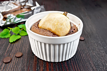 Image showing Cake chocolate with pear in white bowl on board