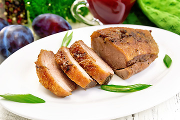 Image showing Duck breast with cabbage and green onions in plate on board