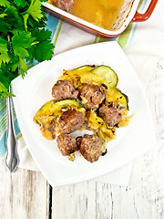 Image showing Meatballs with zucchini and nuts in plate on board top