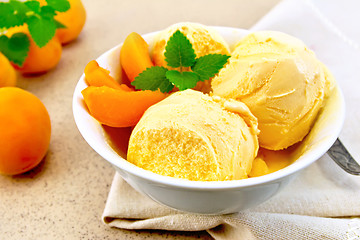Image showing Ice cream apricot in bowl on napkin