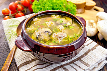 Image showing Soup with meatballs and mushrooms in brown bowl on dark board