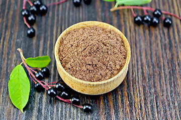 Image showing Flour bird cherry in bowl with berries on dark board