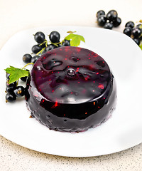 Image showing Jelly from black currant with berries in plate on table