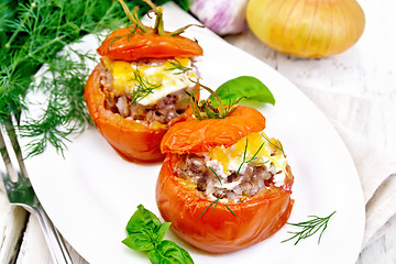 Image showing Tomatoes stuffed with meat and rice in plate on light board