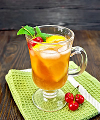 Image showing Lemonade cherry and orange in wineglass on dark board