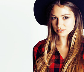 Image showing young pretty brunette girl hipster in hat on white background casual close up dreaming smiling