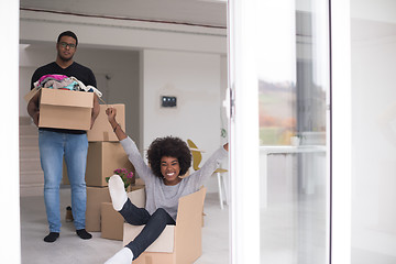 Image showing African American couple  playing with packing material