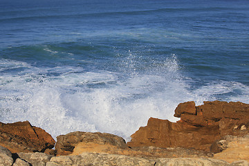 Image showing Marine wave breaks against offshore stone