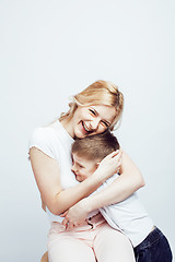 Image showing young modern blond curly mother with cute son together happy smiling family posing cheerful on white background, lifestyle people concept, sister and brother friends