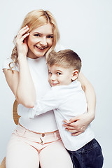 Image showing young modern blond curly mother with cute son together happy smiling family posing cheerful on white background, lifestyle people concept, sister and brother friends