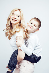 Image showing young modern blond curly mother with cute son together happy smiling family posing cheerful on white background, lifestyle people concept, sister and brother friends