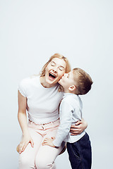 Image showing young modern blond curly mother with cute son together happy smiling family posing cheerful on white background, lifestyle people concept, sister and brother friends