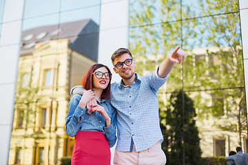 Image showing Happy young couple standing at street of city and laughing on the bright sunny day