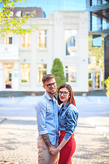 Image showing Happy young couple standing at street of city and laughing on the bright sunny day