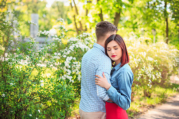 Image showing Happy young couple at park standing and laughing on the bright sunny day