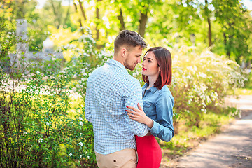 Image showing Happy young couple at park standing and laughing on the bright sunny day