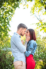 Image showing Happy young couple at park standing and laughing on the bright sunny day