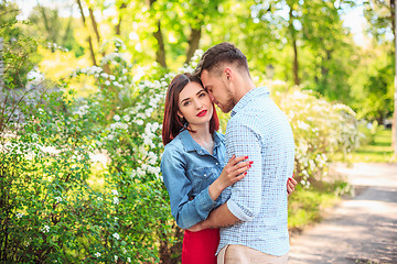 Image showing Happy young couple at park standing and laughing on the bright sunny day