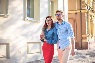 Image showing Happy young couple standing at street of city and laughing on the bright sunny day