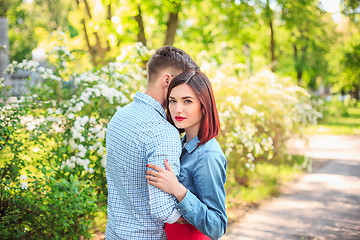 Image showing Happy young couple at park standing and laughing on the bright sunny day